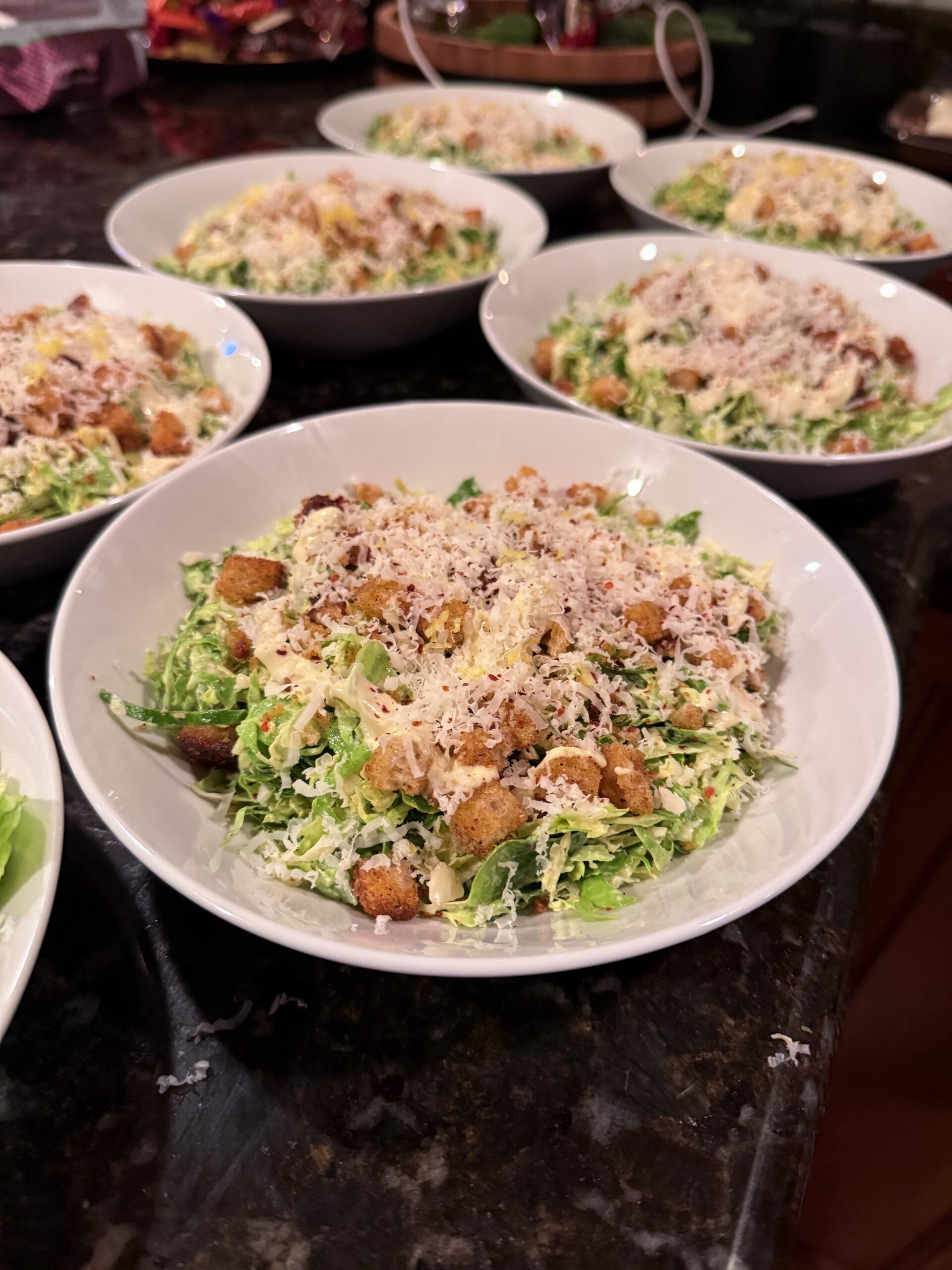Brussels sprout Caesar salad on a white plate