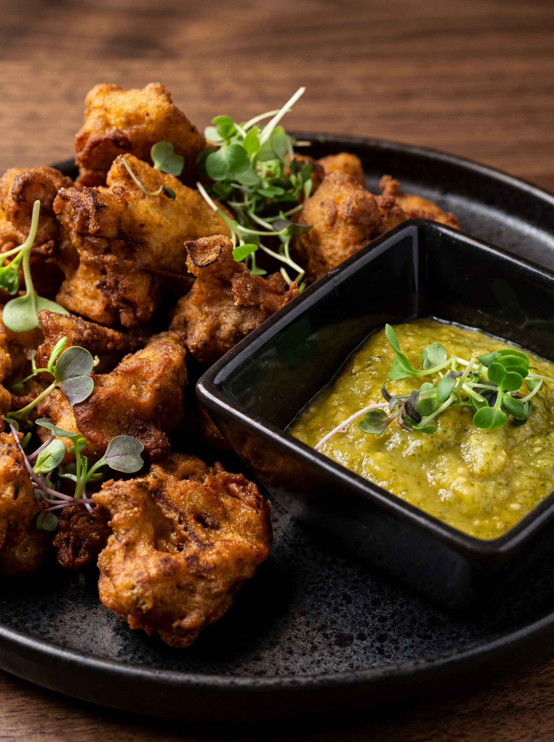 Crispy Cauliflower Bites with Salsa Verde on a white plate