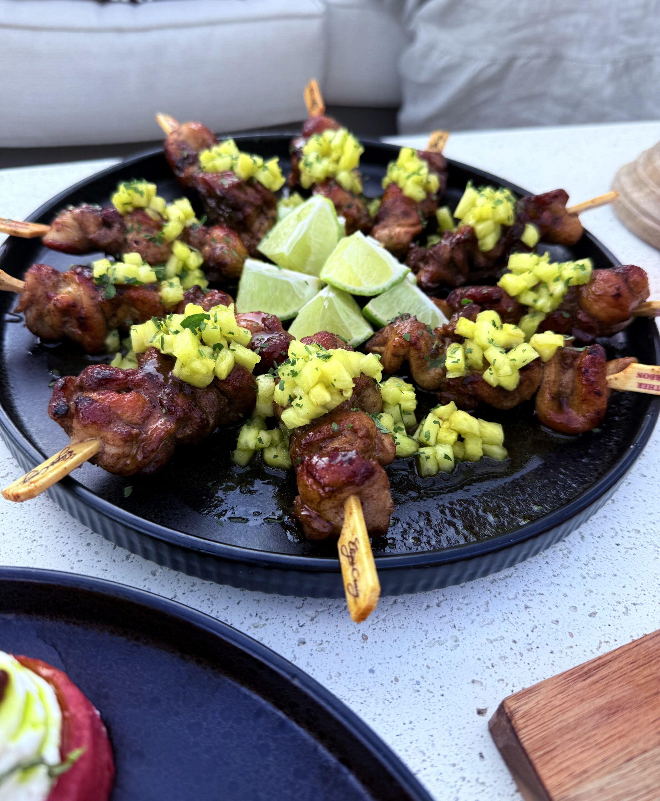 jerk chicken skewers on a white plate