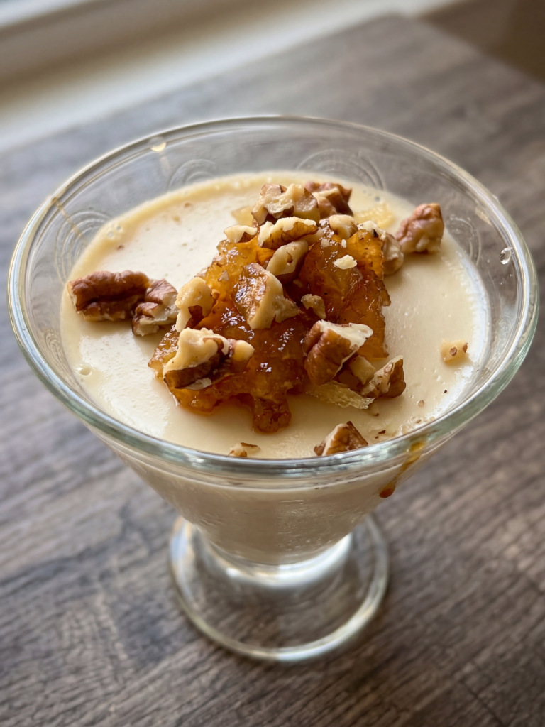 Maple Panna Cotta in a stemless martini glass topped with spiced pear compote and chopped walnuts